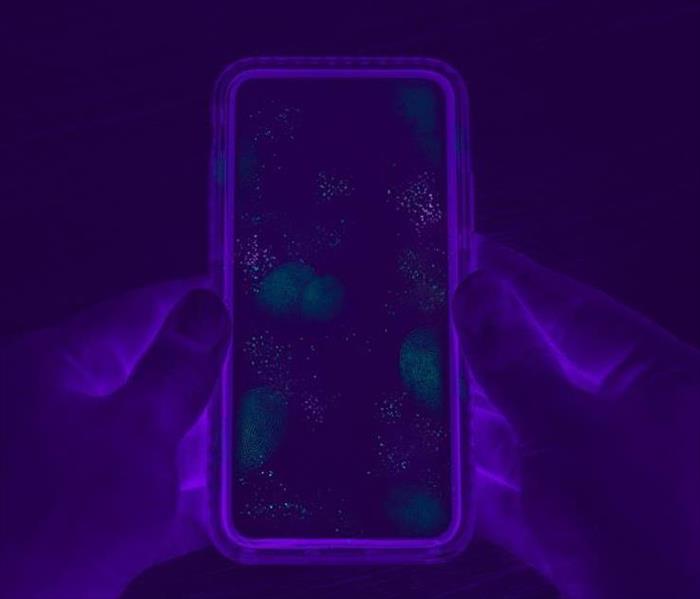 photo of phone in black light to highlight the grems on the phone. 